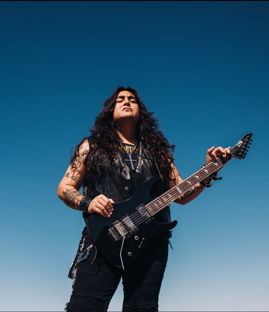 Musician with electric guitar outdoors